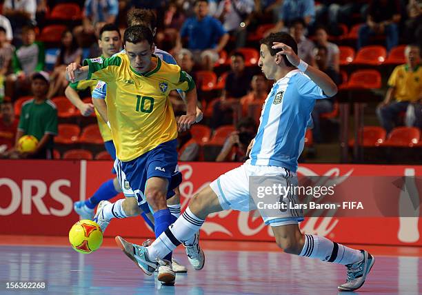 Fernandinho of Brazil is challenged by Maximiliano Rescia of Argentina during the FIFA Futsal World Cup Quarter-Final match between Argentina and...