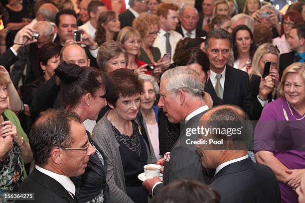 Prince Charles, Prince of Wales meets guests during his 64th birthday celebration who are also celebrating their birthday, at Government House on...