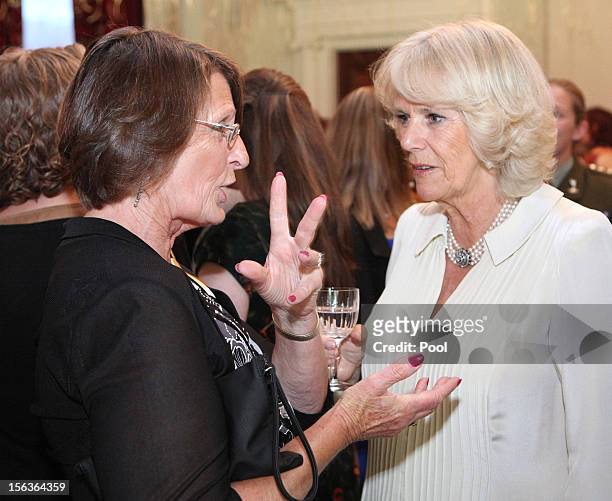 Camilla, Duchess of Cornwall meets guests who are also celebrating their birthday during Prince Charles, Prince of Wales' 64th birthday celebration,...