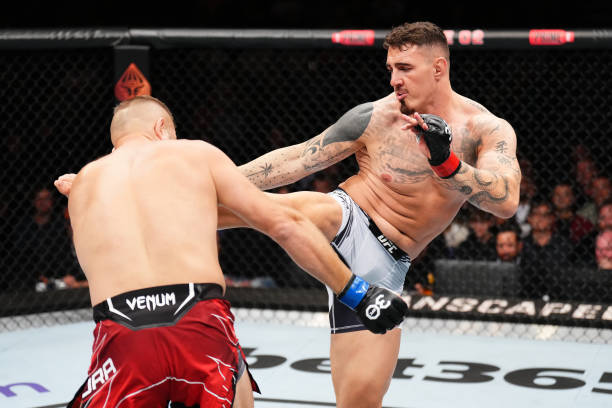 Tom Aspinall of England kicks Marcin Tybura of Poland in their heavyweight fight during the UFC Fight Night at The O2 Arena on July 22, 2023 in...
