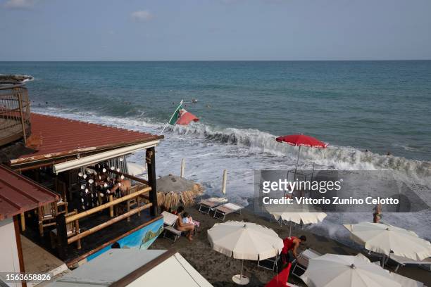 People lay on the beach and swim in the sea on July 22, 2023 in Genoa, Italy. The government has issued red alerts for 16 cities due to the current...