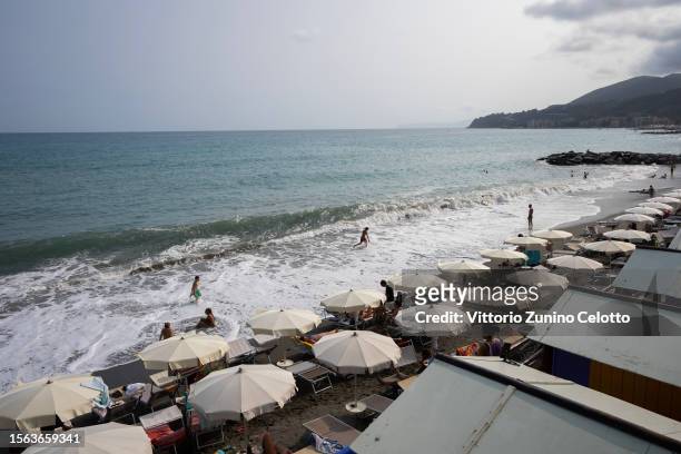 People lay on the beach and swim in the sea on July 22, 2023 in Genoa, Italy. The government has issued red alerts for 16 cities due to the current...