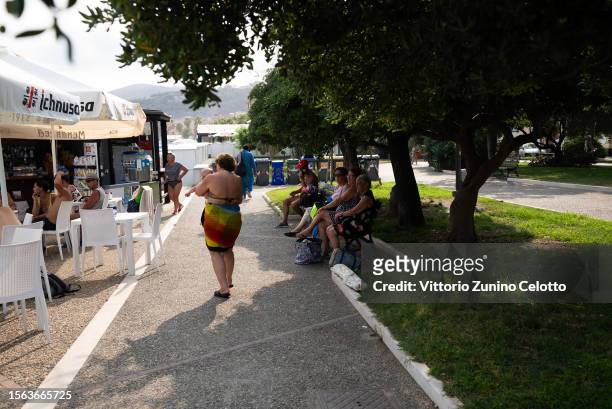 People rest in the shade from trees on July 22, 2023 in Genoa, Italy. The government has issued red alerts for 16 cities due to the current heatwave,...