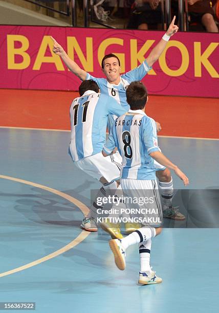 Maximiliano Rescia celebrates with teammates after scoring a goal against Brazil during the quarter-finals match of the FIFA Futsal World Cup 2012 in...