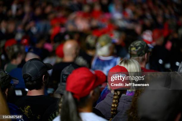 Trump supporters listen as former U.S. President Donald Trump speaks during a political rally while campaigning for the GOP nomination in the 2024...