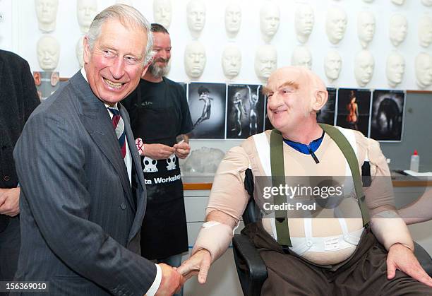 Prince Charles, Prince of Wales shares a laugh with Peter Hambleton, who plays the Dwarf Gloin in the new 'Hobbit' film, at Weta Workshop on November...