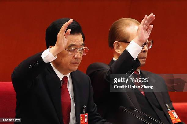 Chinese President Hu Jintao and former president Jiang Zemin vote at the closing of the 18th Communist Party Congress at the Great Hall of the People...