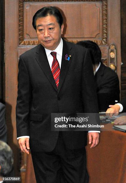 Japanese Prime Minister and ruling Democratic Party of Japan leader Yoshihiko Noda enters to the room to attend the one on one debate with the...