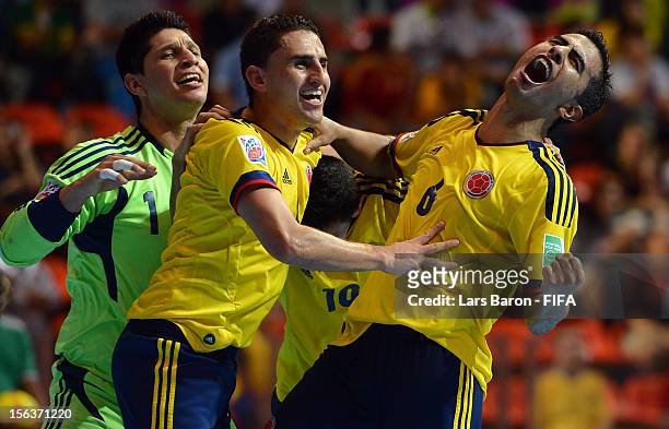 Jorge Abril of Colombia celebrates with team mates goalkeeper Juan Lozano and Miguel Sierra after scoring his teams third goal during the FIFA Futsal...