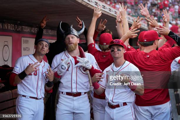 Jake Fraley of the Cincinnati Reds poses for a photo with teammates after hitting a solo home run in the sixth inning against the Arizona...