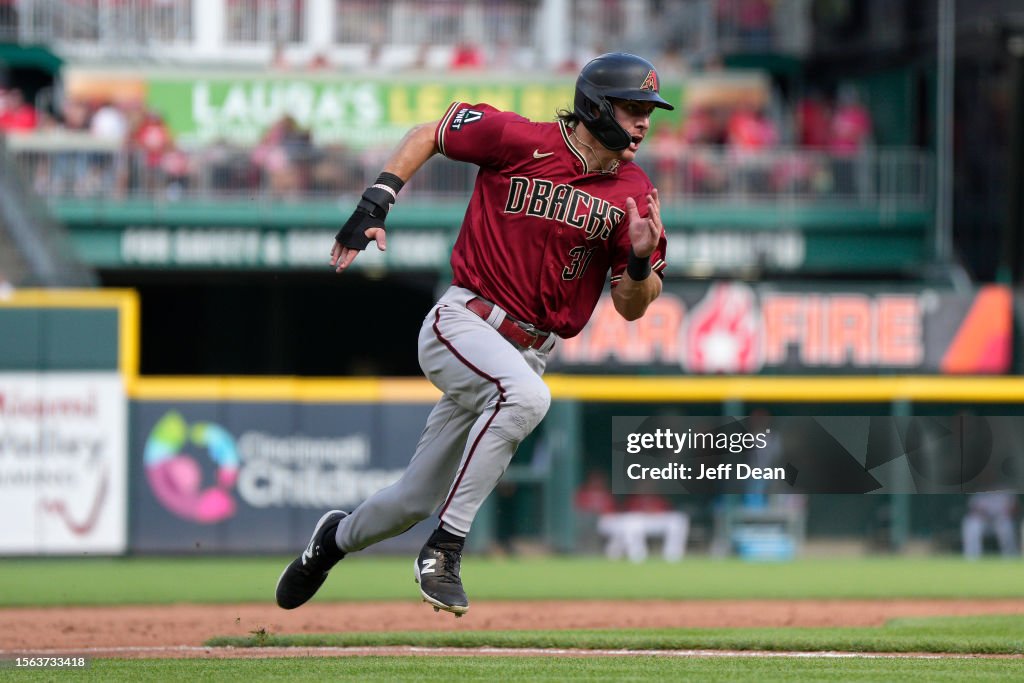 Diamondbacks Front Jake McCarthy of the Arizona Diamondbacks rounds third base to score ...