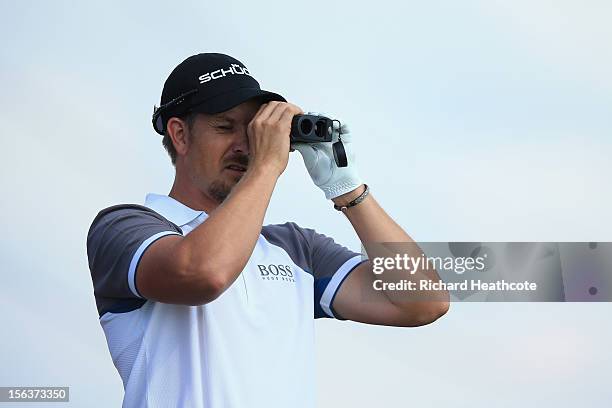 Henrik Stenson of Sweden uses a laser rangefinder during a practise round for the South African Open Championship at the Serengeti Golf Club on...