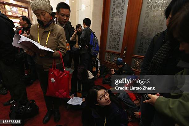 Media wait to be allowed access to the main hall the inside the Great Hall of the People during the closing session of the 18th National Congress of...