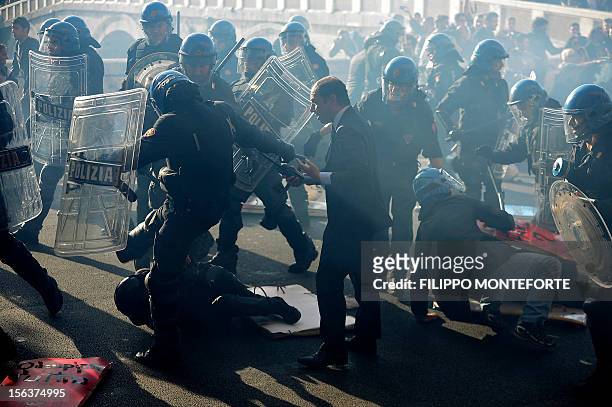 Demonstrators and riot policemen fight during a protest on a day of mobilisation against austerity measures by workers in southern Europe on November...