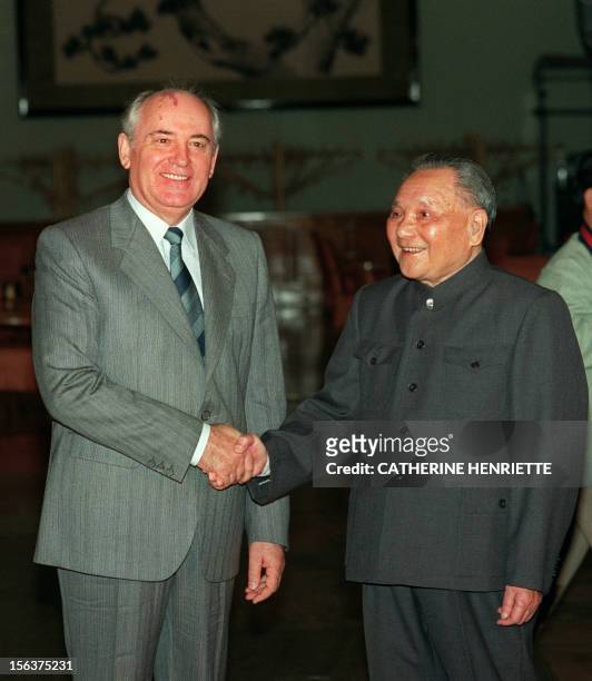 General Secretary of the Soviet Communist Party Mikhail Gorbachev shakes hands with Chinese senior leader Deng Xiaoping 16 May 1989 in Beijing prior...