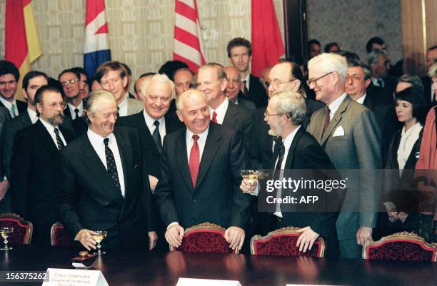 Soviet President Mikhail Gorbachev is all smiles, while joining Foreign Ministers Roland Dumas of France , Eduard Shevardnadze of Soviet Union , US...