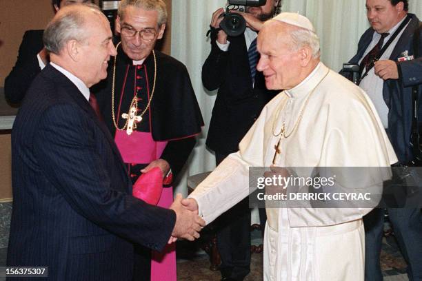 Pope John Paul II greets Soviet leader Mikhail Gorbachev as Monsignore Manuzzi looks on, on December 01, 1989 in Roma, during an hictoric meeting at...