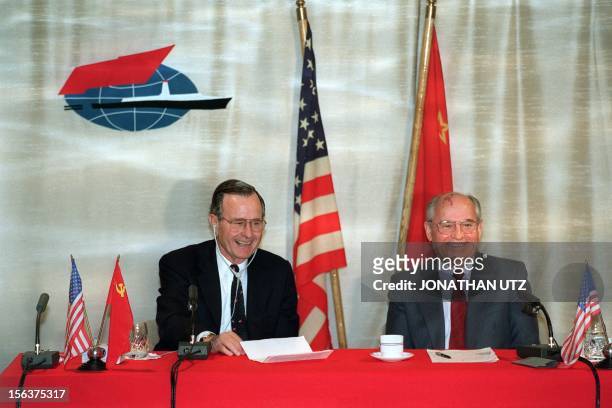 President George Bush shares a joke with Soviet leader Mikhail Gorbachev on December 03, 1989 on board the soviet cruise "Maxim Gorki", shipdocked at...