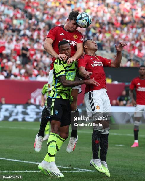 Gabriel Magshaes of Arsenal, Harry Maguire of Manchester United and Amad of Manchester United battle for the ball during their Pre-Season friendly...
