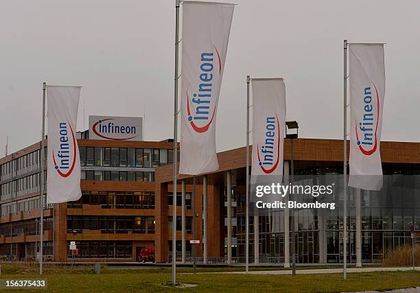 Infineon Technologies AG flags are seen flying outside the company's headquarters in Munich, Germany, on Wednesday, Nov. 14, 2012. Infineon...