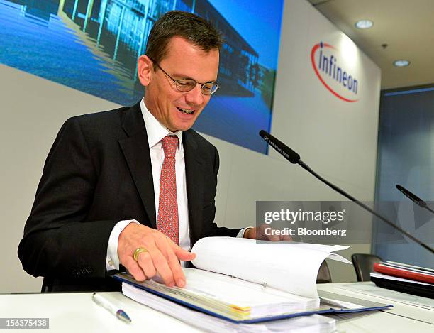 Dominik Asam, chief financial officer of Infineon Technologies AG, checks his paperwork ahead of the company's earnings news conference in Munich,...