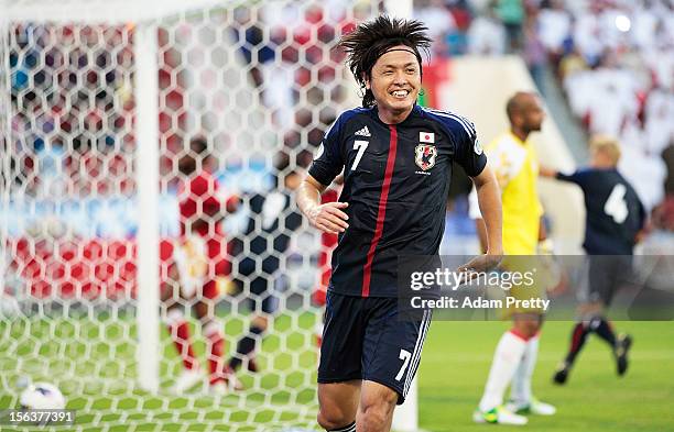 Yasuhito Endo of Japan celebrates after setting up the winning goal during the FIFA World Cup Asian qualifier match between Oman and Japan at Sultan...