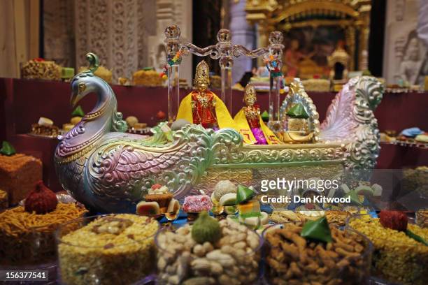Foods are laid out inside the shrine ahead of a ceremony as Sadhus and Hindus celebrate Diwali at the BAPS Shri Swaminarayan Mandir on November 14,...