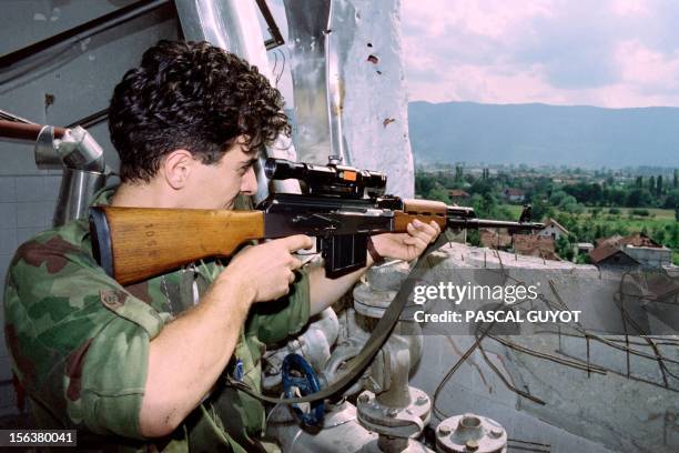 Bosnian fighter aims his sites on a Serbian position in the Dobrinja district, one of the most dangerous sites on the frontline in the Bosnian...