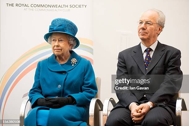 Queen Elizabeth II and Royal Commonwealth Society Chairman Peter Kellner sit on stage during her visit to the Royal Commonwealth Society on November...