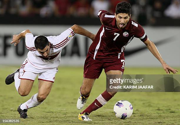 Qatar's Wissam Rizq challenges Lebanon's Hassan Maatuk during their 2014 World Cup Asian zone group A qualifying football match in Doha on November...