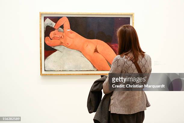 Visitor considers the painting 'Nude' of Amedeo Modigliani at the exhibition 'Visions Of Modernity' at the Deutsche Guggenheim on November 14, 2012...