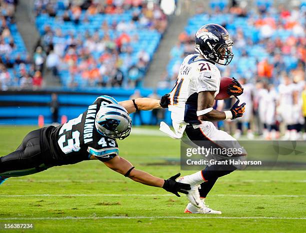 Ronnie Hillman of the Denver Broncos breaks away from Haruki Nakamura of the Carolina Panthers for a touchdown during play at Bank of America Stadium...
