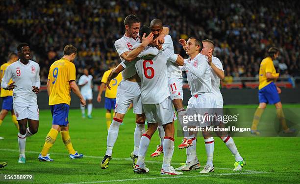 Steven Caulker of England celebrates scoring to make it 2-1 with team mates during the international friendly match between Sweden and England at the...