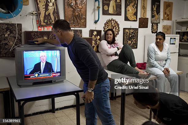 Israelis watch Israeli PM Benjamin Netanyahu on TV in a bomb shelter on November 14, 2012 in Netivot, Israel. Israel Defense Forces launched aerial...