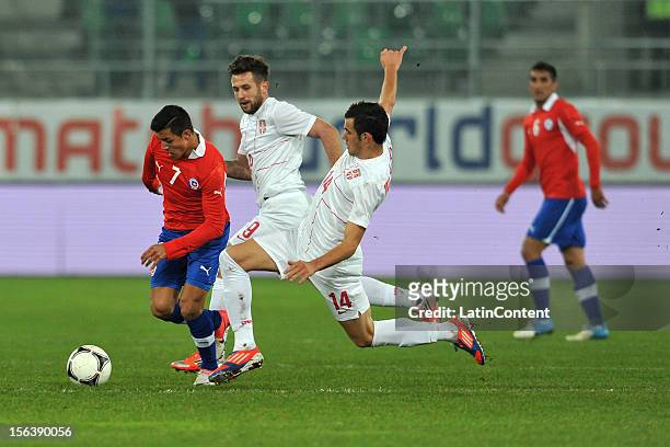 Luka Milivojevic of Serbia struggles for the ball with Alexis Sanchez of Chile during the FIFA Friendly match between Chile and Serbia at Arena Saint...