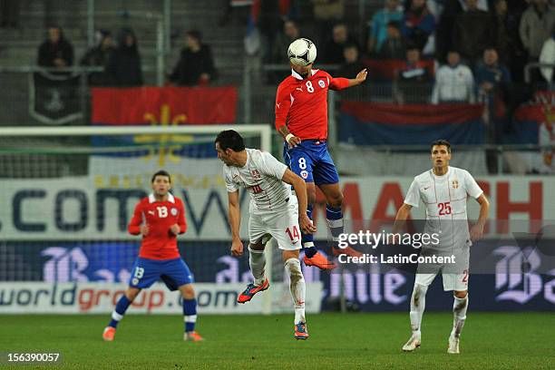 Luka Milivojevic of Serbia struggles for the ball with Arturo Vidal of Chile during the FIFA Friendly match between Chile and Serbia at Arena Saint...