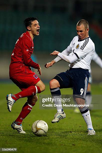 Mario Mutsch of Luxembourg is tackled and fouled by Kenny Miller of Scotland during the International Friendly match between Luxembourg and Scotland...
