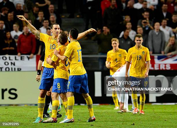 Sweden's striker and team captain Zlatan Ibrahimovic celebrates with his teammates after scoring his 3rd goal of the match during the FIFA World Cup...