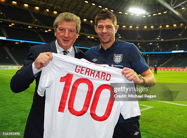 England manager Roy Hodgson presents Steven Gerrard with a shirt celebrating his 100th international cap after the international friendly match...