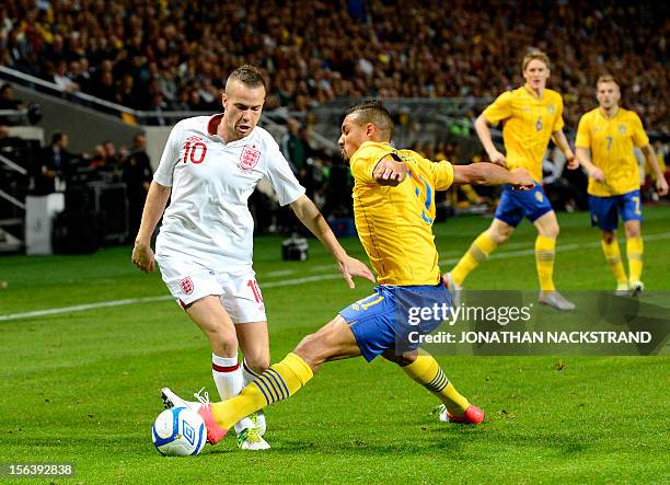 Sweden's striker Mathias Ranzgie vies with England's midfielder Tom Cleverley during the FIFA World Cup 2014 friendly match England vs Sweden in...