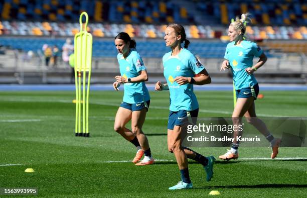 Aivi Luik, Hayley Raso and Ellie Carpenter run during an Australia Matildas open training session at the FIFA Women's World Cup Australia & New...