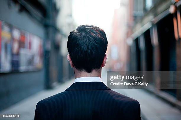 man looking down the alley - back view ストックフォトと画像