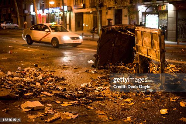 Taxi rides past a burnt garbage container after a demonstration near the Spanish parliament turned violent on November 14, 2012 in Madrid, Spain. A...