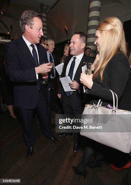 David Cameron shows armed forces support at the 'Give Us Time' fundraiser held at Corinthia Hotel London on November 14, 2012 in London, England.