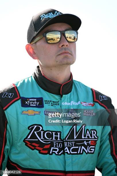Ryan Ellis, driver of the Rich Mar/Laughlin Family Fnd. Chevrolet, walks the grid the NASCAR Xfinity Series Pocono 225 at Pocono Raceway on July 22,...