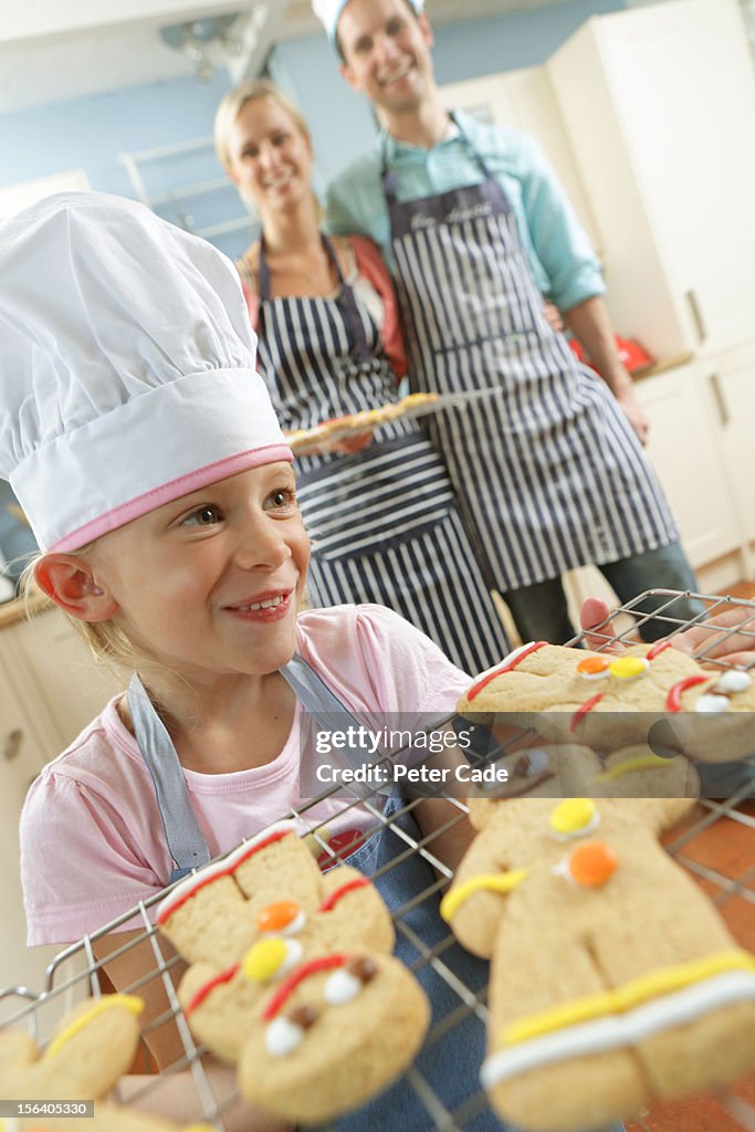 Family in kitchen baking gingerbread men