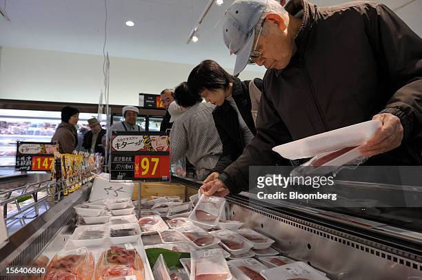 Customers browse packaged fish in a Seiyu GK supermarket in Tokyo, Japan, on Wednesday, Nov. 14, 2012. Seiyu GK is a unit of Wal-Mart Stores Inc....