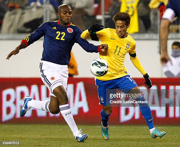 Neymar of Brazil and Aquivaldo Mosquera of Colombia fight for the ball during a FIFA Friendly match between Colombia and Brazil at MetLife Stadium on...