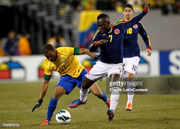 Lucas of Brazil fights for the ball with Pablo Armero of Colombia during a FIFA Friendly match between Colombia and Brazil at MetLife Stadium on...
