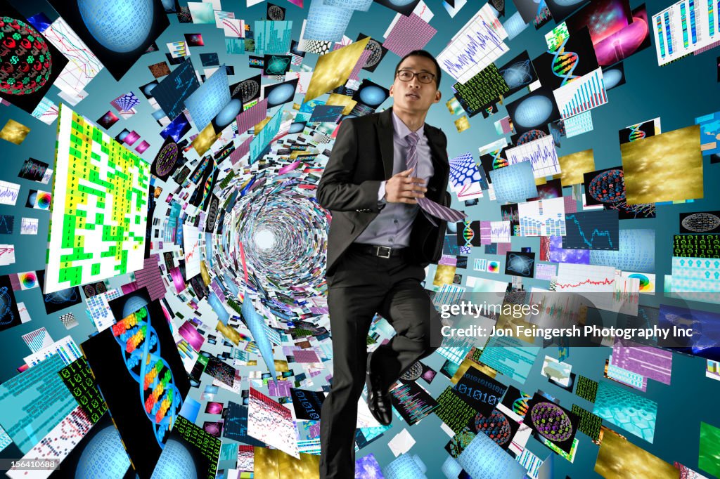 Asian businessman surrounded by science images